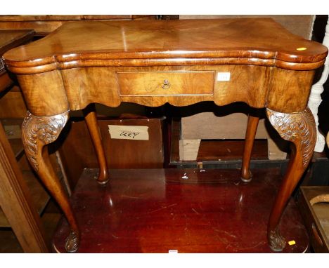 An early Georgian style figured walnut and crossbanded baize lined fold-over card table, having single frieze drawer, proud c