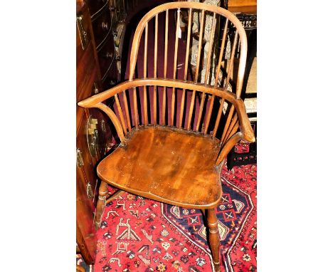 An elm and oak comb back Windsor chair, with crinoline stretcher, width 67cm