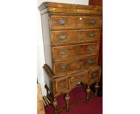 A figured walnut and crossbanded chest on stand in the William &amp; Mary style, the four drawer upper section over base fitt