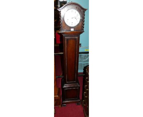 An early 20th century oak grandmother clock, having circular silvered dial, striking and chiming movement (lacking pendulum),