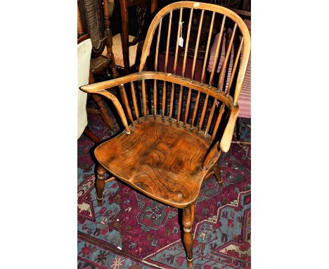 An elm and oak comb back Windsor chair, with crinoline stretcher, width 67cm