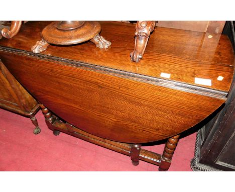 A 19th century joined oak drop leaf dining table, having a gateleg action and on bobbin turned supports, width 104cm