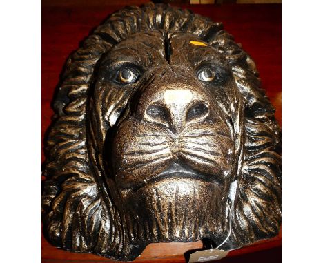 A contemporary gilt painted ceramic lions head, 42 x 43cm