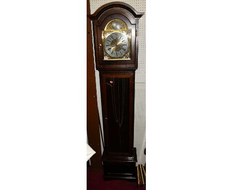 A contemporary oak longcase clock by Interclock, having a glazed trunk door, triple weight driven movement, pendulum and thre