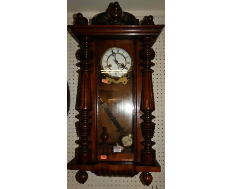 An early 20th century walnut Vienna droptrunk wall clock