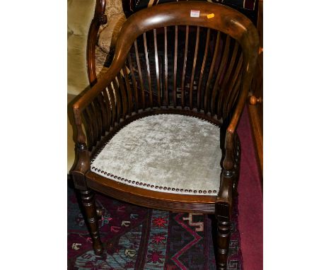 An Edwardian mahogany comb back tub armchair, having a velour upholstered studded seat raised on ring turned forelegs, width 