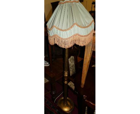 A giltwood turned and fluted standard lamp, with shade