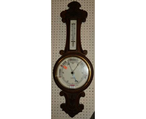 An early 20th century carved oak aneroid two-dial wheel barometer, the dial signed W.Jarrold, Stowmarket, h.77cm