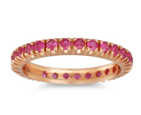 A RUBY ETERNITY RING, the circular stones mounted in 18ct yellow gold. Estimated: weight of rubies: 0.75 ct, size R