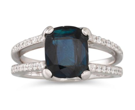 A DEEP BLUE SAPPHIRE AND DIAMOND RING, the cushion cut sapphire to a split diamond shoulders, mounted in yellow gold. Togethe