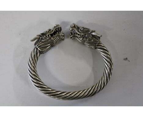 A white metal dragon head bangle 