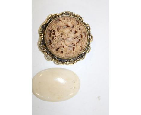 A Chinese carved ivory brooch with a gold coloured mount, sold with a antique South Sea Island Netsuke of Mermaid form. Netsu