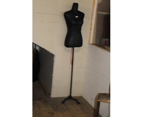 A mannequin torso on a cast iron stand Height 1.63 mtr 