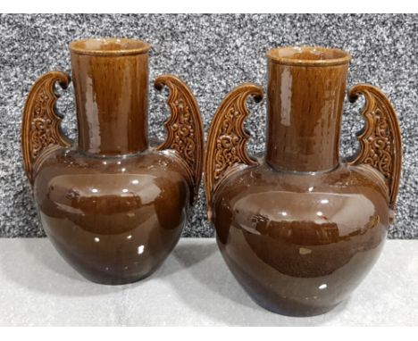 Pair of brown ceramic vases with decorative handles