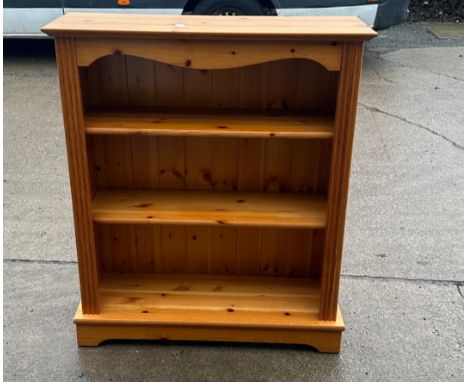 Pine three shelf bookcase measures approx 40 inches tall by 34 wide and 12 deep 