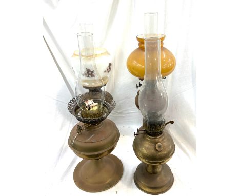 Selection of copper and brass vintage oil lamps with funnels, tallest measures approximately 23 inches 