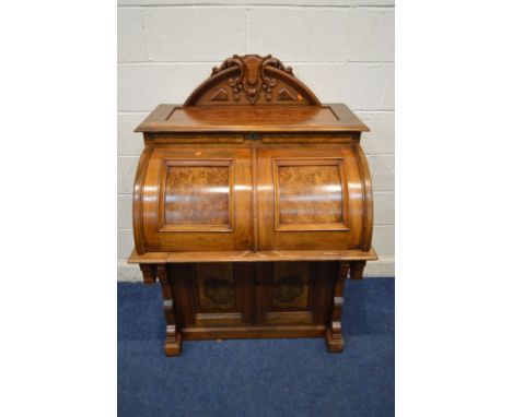 AN EARLY 20TH CENTURY KEARNEY AND WIGGERS WALNUT AND BURR WALNUT MECHANICAL DESK, with a removable carved crest with finial a