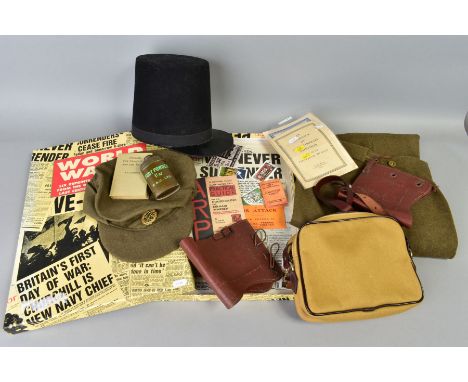 A BOX CONTAINING A NUMBER OF MILITARY RELATED ITEMS to include WWII era uniform trousers and ARP cap, 1941 dated leather 'cha