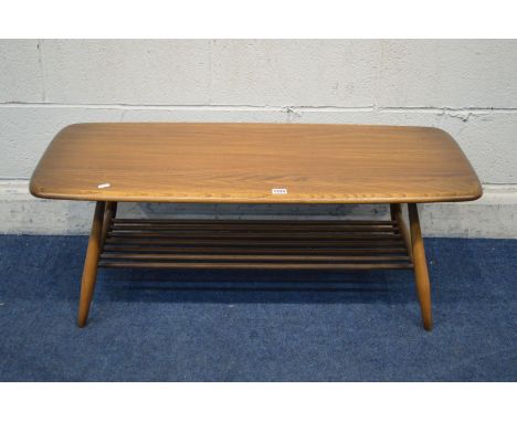 AN ERCOL GOLDEN DAWN RECTANGULAR COFFEE TABLE on cylindrical tapering legs united by a spindled undertier, width 104cm x dept