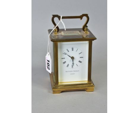 A MATTHEW NORMAN OF LONDON BRASS CASED CARRIAGE CLOCK, white enamel dial with Roman numerals, back plate marked 'Matthew Norm