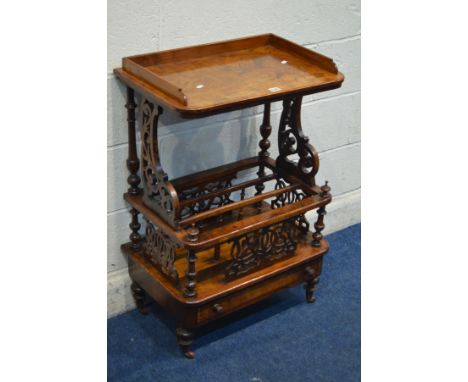 A VICTORIAN BURR WALNUT CANTERBURY, having a gallery top, on a pair of foliate scrolling and turned upright supports, with th