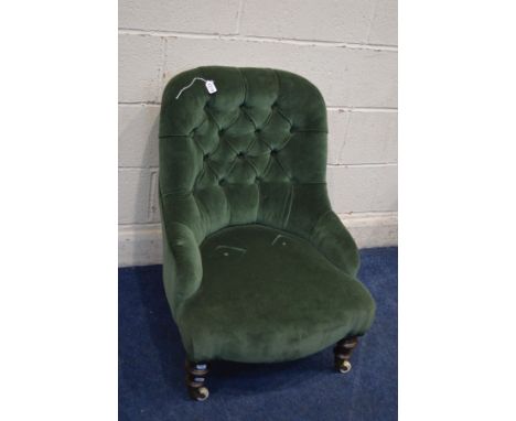 A LATE VICTORIAN GREEN UPHOLSTERED BEDROOM CHAIR on ceramic casters