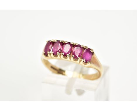 A 9CT GOLD RUBY RING, designed with five oval cut claw set rubies, to a plain polished band, hallmarked 9ct gold Birmingham, 