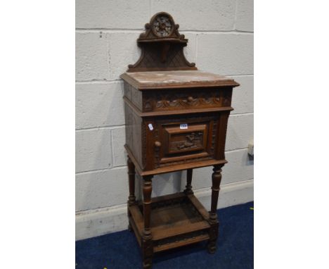 AN EARLY 20TH CENTURY CARVED OAK BRETON POT CUPBOARD, with a veined marble top, and single drawer and ceramic interior, width