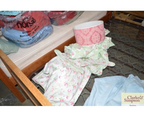 A quantity of rose and strawberry patterned roller blinds and curtains etc.