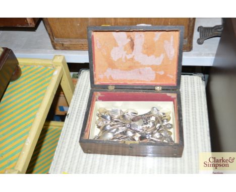 A mother of pearl inlaid trinket box and contents of souvenir spoons
