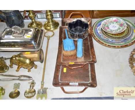 A pair of copper trays, stamped J P together with enamel dressing table brushes and a silver plated wine coaster