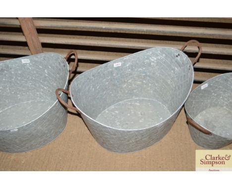 A large galvanised twin handled planter