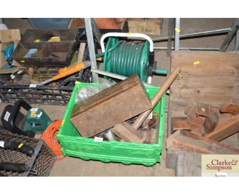A box of hand tools and a hose and reel