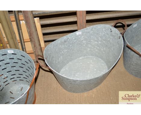 A large galvanised twin handled planter