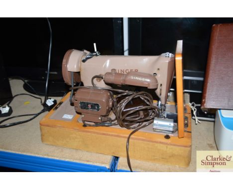 A Singer sewing machine in fitted case sold as collectors item