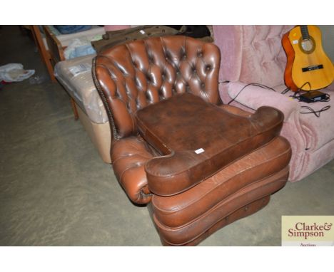 A leather and button down upholstered armchair
