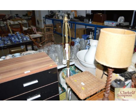 A brass and floral decorated standard lamp on tripod base lacking shade