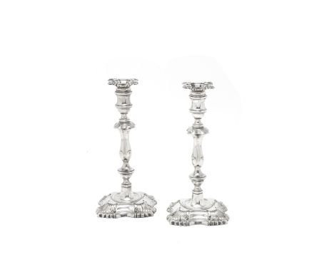A matched pair of large silver candlesticksWilliam Hutton &amp; Sons Ltd, London 1902, 1909, one drip pan 1908In the 18th cen