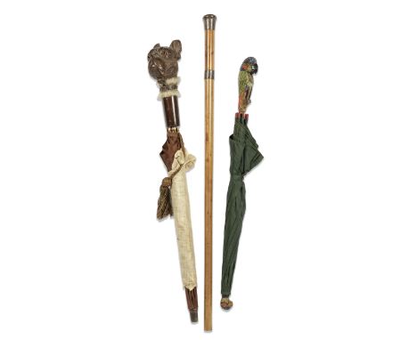 An early 20th century Black Forest carved and stained wood French bull dog's head handled novelty umbrella together with a ca