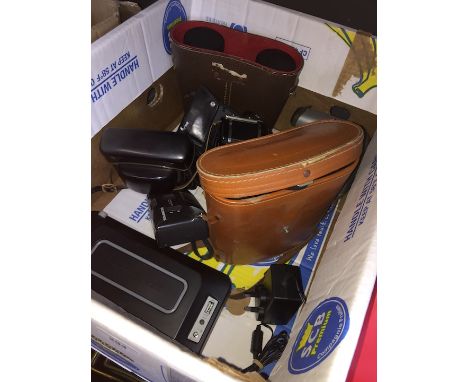 A box of cameras to include Polaroid, Olympus, etc, 2 pairs of binoculars in cases and a radio 