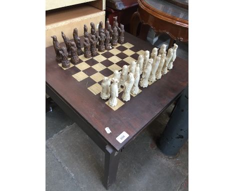 A chess and backgammon table with Chinese style chess pieces. 