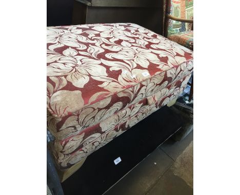 A burgundy floral pouffe 