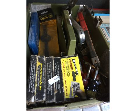 A small box of tools including a stapler 