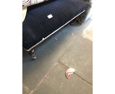 A pouffe with brass castors 
