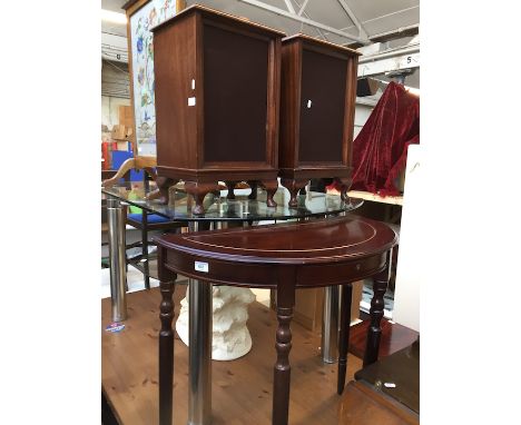 A pair of speaker cabinets and a demi lune table 