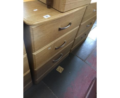 A modern light wood effect low chest of 3 drawers 