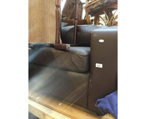 A dark brown leather sofa bed 