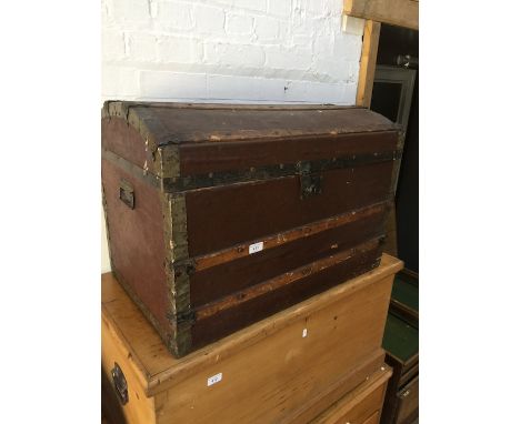 A Vintage metal bound domed top trunk 