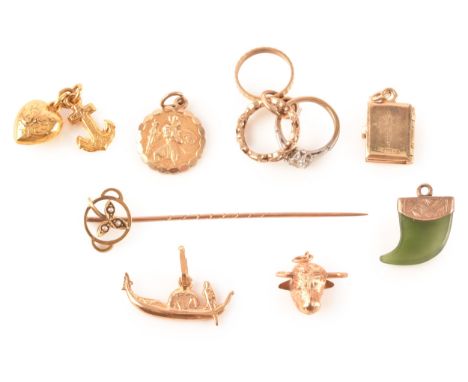 A group of 9ct yellow gold charms, to include a bible, an anchor and heart link charm, a holy bible, together with a yellow m