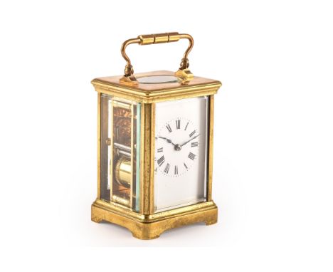 An early 20th century brass carriage clock, white enamel dial and black Roman numerals, striking on a single gong, in a fitte